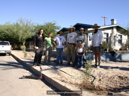 2B Tree planters with tree just planted 2006. We irrigate the first year to get the tree established before harvested rainwater becomes sole water source wm