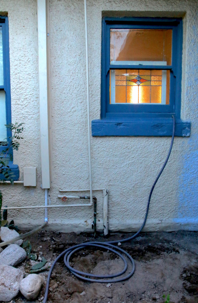 Figure 4. Hose coming out of bathroom wall. Hose is daily moved to a different plant/zone to keep soils healthy, aerobic, and odor-free. Photo credit: Moses Thompson.